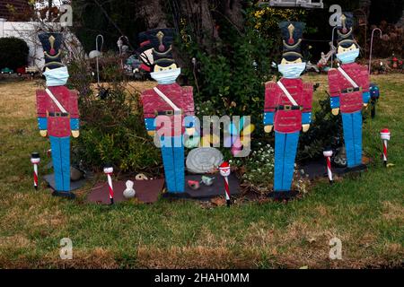 CHRISTMAS TOY SOLDIERS In the age of covid, a yard is decorated with traditional nutcracker soldiers but this, year, wearing masks. In Queens, NYC. Stock Photo