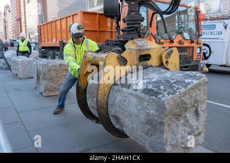 A new York City Parks Dept. worker puts a barricade in place at the East 14th St. perimeter of Union Square Park in downtown Manhattan, New York City. Stock Photo