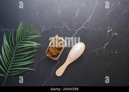 The wooden bowl with rehydrated henna on table Stock Photo