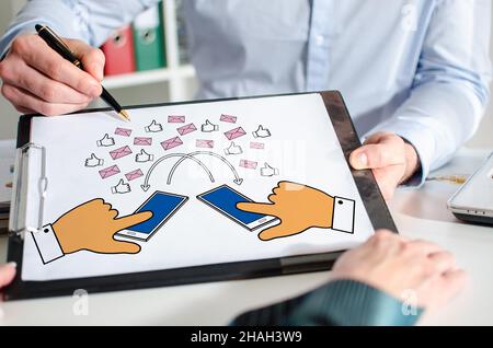 Businessman showing digital communication concept on a clipboard Stock Photo