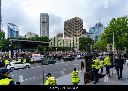 Large crowd of protesters against No Jab No Job policy of Australian government. In view are Sydney Eye Tower, buildings, road, cars and police force.