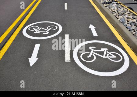 On the asphalt road signs for cyclists in both directions, allowing their vehicles for walking Stock Photo