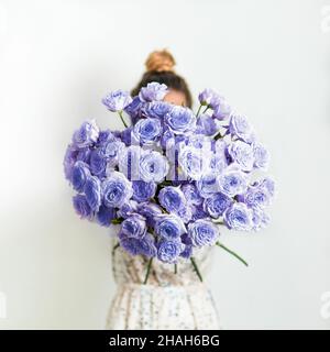 Close up view of nice delicate purple bouquet or bunch with violet roses. Demonstrating color of 2022 year very peri in floristic and wedding. Live bouquet of violet roses for valentines day Stock Photo