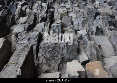 The texture of the stone, laid out on the wall, of different shapes and shades for the entire frame Stock Photo