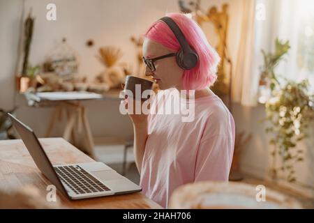 Female potter using laptop in art studio Stock Photo