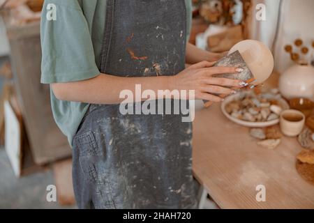 Woman ceramist making clay craft for sale in workroom Stock Photo