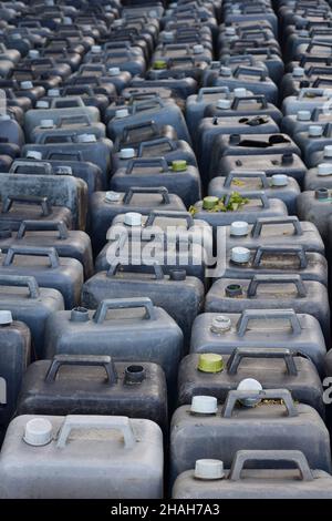 The entire frame is filled with rows of old plastic gray canisters, closed and open. Stock Photo