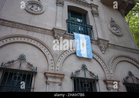Argentinian flag hangs down vertically from balcony of historic building in Mendoza city. National flag of Argentina on facade of monumental building Stock Photo