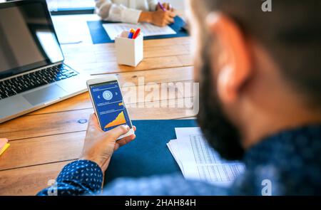 Businessman looking mobile with bitcoins information Stock Photo