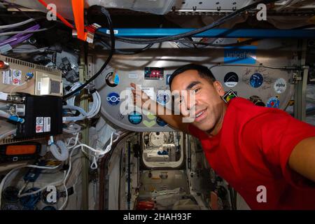 ISS - 05 December 2021 - NASA astronaut and Expedition 66 Flight Engineer Raja Chari is pictured inside the Columbus laboratory module pointing to the Stock Photo