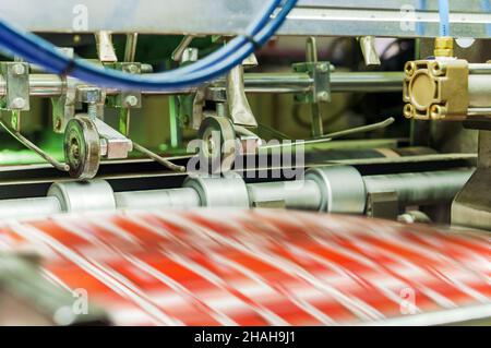 Printing house. Printing equipment. Machine for varnishing printed products. Processing after offset printing. Stock Photo