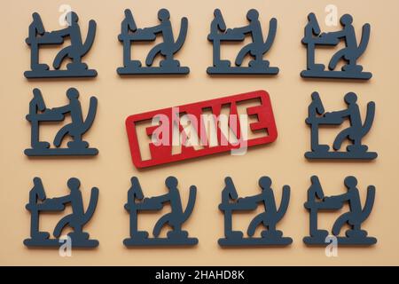Fake news and propaganda in internet concept. Figures with a computer. Stock Photo