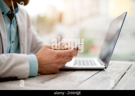 Side view of man in suit checking emails on smart phone. Stock Photo