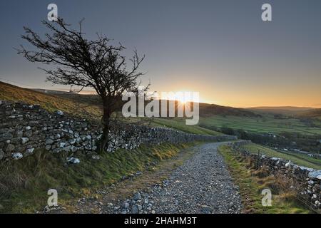 Sunrise view at Upper-Wharfedale in the Yorkshire Dales, with a view down Cam Head, above the village of Kettlewell. Stock Photo