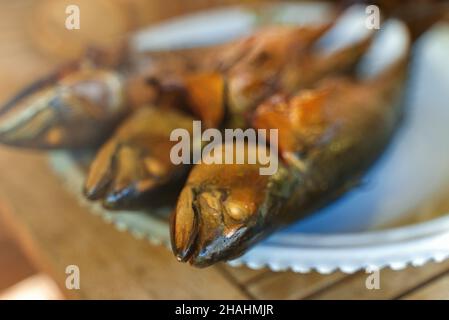 Fresh hot smoked mackerel on the table. Stock Photo