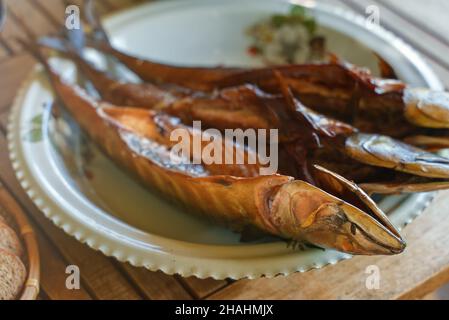 Fresh hot smoked mackerel on the table. Stock Photo