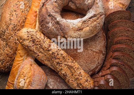 Bread of different types in close-up. Bread background. Bakery products. Stock Photo