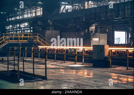 Hot steel pipe on the conveyor in Iron and Steel Factory or Pipe Mill located in Taganrog South of Russia Stock Photo
