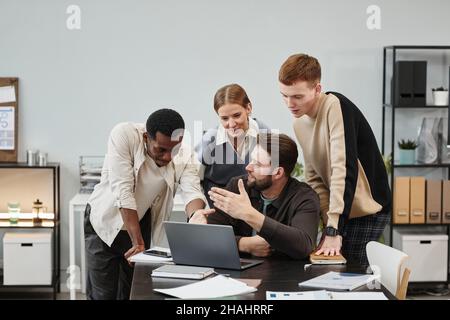 Group of business colleagues working in team at office, they using laptop working over online presentation at the table Stock Photo