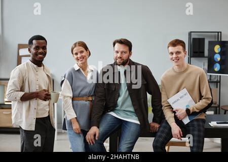 Portrait of successful business team smiling at camera while standing at office Stock Photo