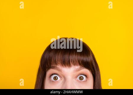 Cropped view portrait of attractive shocked girl looking at you wow sale copy space isolated over bright yellow color background Stock Photo