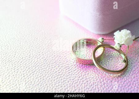 Couple of wedding rings on textured background Stock Photo