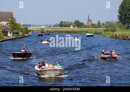 WARMOND, NETHERLANDS - May 20, 2018: Busy Leede river near Warmond, Netherlands, with recreational boats on a sunny sunday in spring Stock Photo