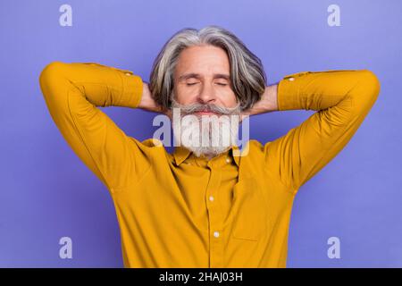 Portrait of attractive dreamy gray-haired man resting nap slumber isolated over bright violet purple color background Stock Photo