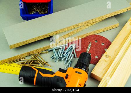 furniture assembly tools, screws, chipboard screwdriver ruler sandpaper Stock Photo