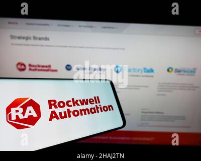 Mobile phone with logo of American company Rockwell Automation Inc. on screen in front of business website. Focus on left of phone display. Stock Photo
