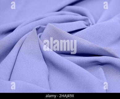 Linen, cotton pleated. Abstract textile background. The color of 2022 is Very Peri. Concept, sewing, tailor shop. Stock Photo
