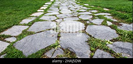 Paving stone coating in perspective. Old Stone Road Stock Photo