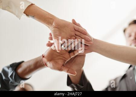 Low angle view of business people holding hands working in team Stock Photo