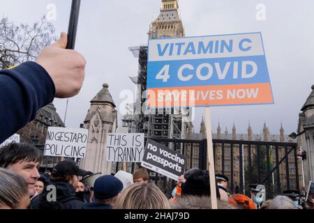 Twenty-fours after another 48,854 Covid infections and 52 deaths were recorded in the UK and government announced a mass booster vaccination programme against the Omicron Covid variant, anti-vaxxers protest about loss of freedoms outside the British parliament, on 13th December 2021, in London, England. Stock Photo