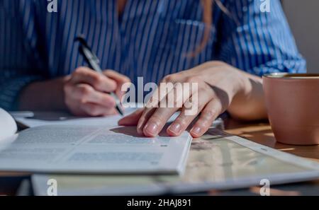 Books and notebooks on wood desk in cafe or library. Concept of research and searching answers in textbooks. Stock Photo