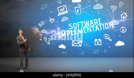 Businessman defending with umbrella, modern technology concept Stock Photo