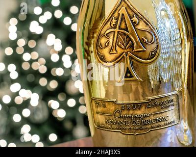 Armand de Brignac 'Ace of Spades'' CHAMPAGNE fine luxury distinctive metallic gold  champagne bottle with sparkling celebration lights behind Stock Photo