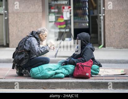TORONTO, CANADA - Oct 12, 2019: The Conversation:  Taken in Toronto two people engage in a very lively conversation. Stock Photo