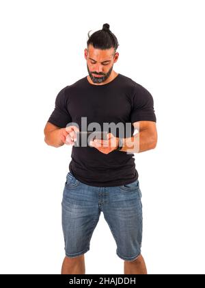Attractive muscular man using electronic tablet in studio Stock Photo