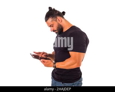 Attractive muscular man using electronic tablet in studio Stock Photo