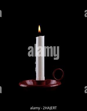 One candle burning brightly on black background Stock Photo