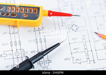 Yellow voltage indicator in close-up on the electrical diagram. Testing and verification of power grids Stock Photo