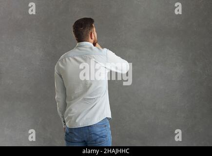 Back view of man look at copyspace thinking Stock Photo