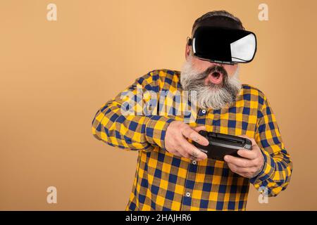 Bearded hipster man wears a head-mounted display, games, excitement, surprised. Stock Photo