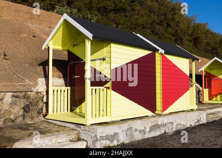 Bright and colourful beach huts on the sea front in Folkestone in Kent. Stock Photo