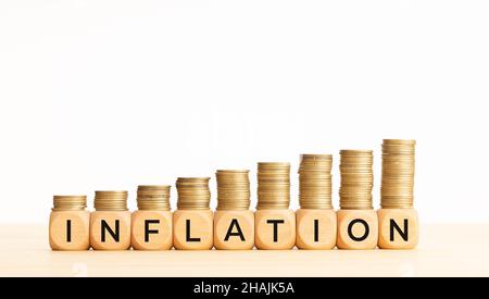 Inflation concept. Text on wooden blocks and stacked coins. Copy space Stock Photo