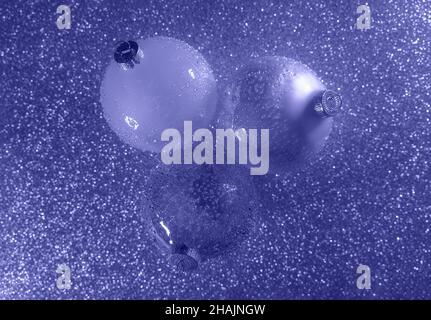 Abstract gradient glitter with Christmas glass baubles. Toned in trendy color of year 2022. Christmas and New Year concept in flat lay style. Copy space. Stock Photo
