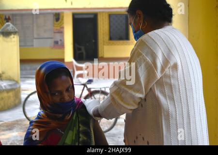 Jamui, India. 13th Dec, 2021. A woman receives a dose of COVISHIELD, a vaccine against the coronavirus disease (COVID-19) at a health centre on an outskirt area in Simultala, Bihar. (Photo by Sudipta Das/Pacific Press) Credit: Pacific Press Media Production Corp./Alamy Live News Stock Photo