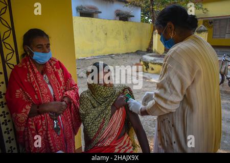 Jamui, India. 13th Dec, 2021. A woman receives a dose of COVISHIELD, a vaccine against the coronavirus disease (COVID-19) at a health centre on an outskirt area in Simultala, Bihar. (Photo by Sudipta Das/Pacific Press) Credit: Pacific Press Media Production Corp./Alamy Live News Stock Photo