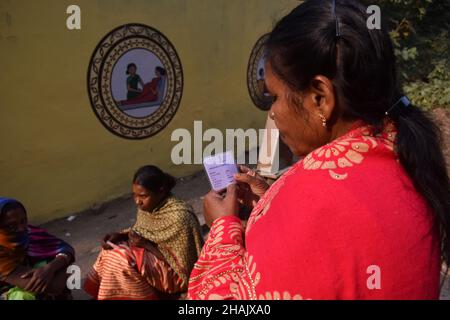 Jamui, India. 13th Dec, 2021. A health worker checks the Identity Card of the beneficiaries before given a dose of COVISHIELD vaccine, a coronavirus disease (COVID-19) vaccine at a health centre on an outskirt area in Simultala, Bihar. (Photo by Sudipta Das/Pacific Press) Credit: Pacific Press Media Production Corp./Alamy Live News Stock Photo